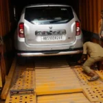 Car being loaded into a vehicle carrier by Mahalaxmi Packers and Movers for safe car transport from Madurai.