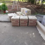 Carton boxes packed with clothes and mixed household items in Paramakudi