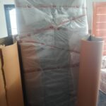 Mattress fully wrapped in bubble wrap and secured with Mahalaxmi Packers and Movers branded tape with corrugated cardboard side protection during house shifting in Madurai