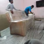 Professional sofa packing service by Mahalaxmi Packers and Movers in Madurai using protective wrapping.